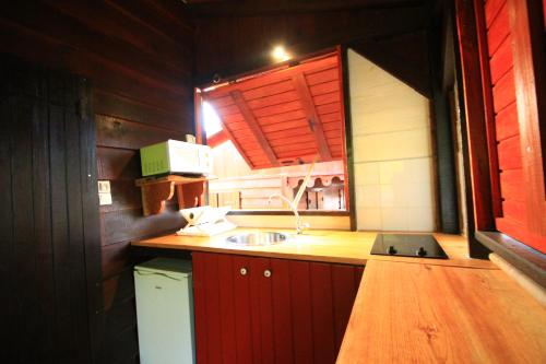 a small kitchen with a sink and a window at Gîtes BB in Bouillante