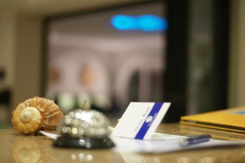a table with a card and some shells on it at Castro Hotel in Amoudara Herakliou