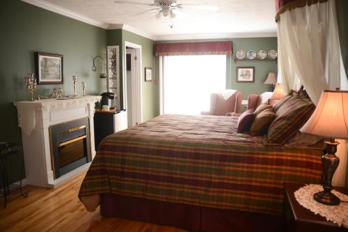 
a bedroom with a bed and a fireplace at Côté's Bed & Breakfast in Grand Falls
