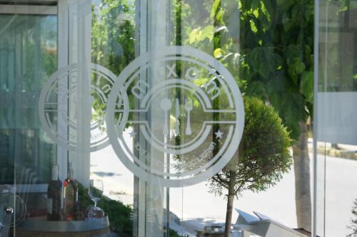 a glass window with a reflection of a tree in it at Castro Hotel in Amoudara Herakliou