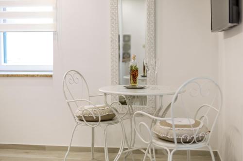 a dining room with two chairs and a table at Split Center Apartments in Split