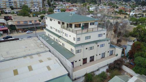 an aerial view of a large white building at Alto El Quisco in El Quisco