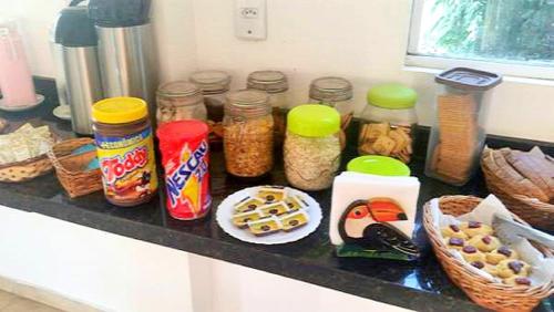 a kitchen counter with jars of food and other foods at Pousada Sol da Trindade in Trindade