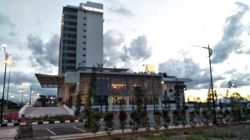 a building with a lot of trees in front of it at UCSI Hotel Kuching in Kuching