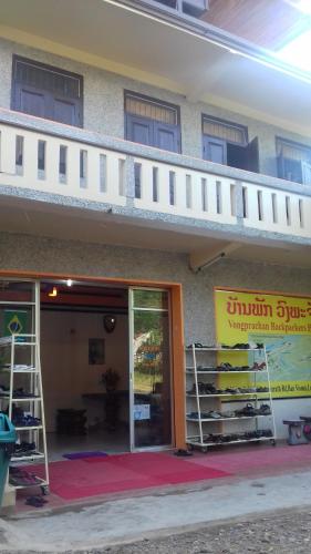 a building with a staircase on top of it at Vongprachan Backpackers Hostel in Luang Prabang