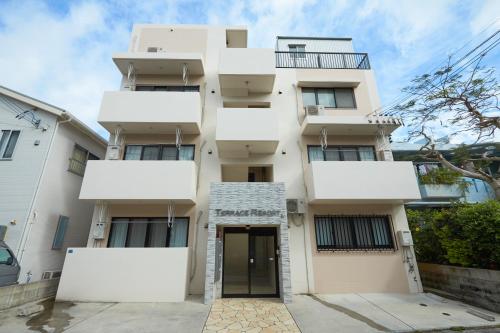 an apartment building with a door in front of it at Terrace Resort Ginowan in Ginowan