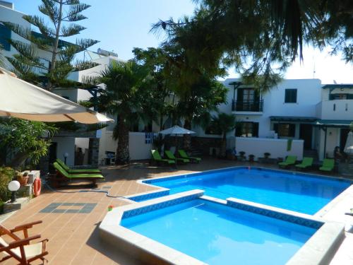 a swimming pool in front of a building at Ioanna Apartments in Agios Prokopios