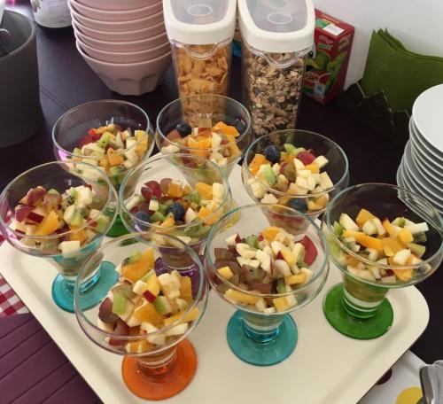 a tray filled with bowls of fruit and other snacks at Landhaus Lilly in Obertraun