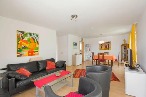 a living room with a couch and a table at Apart Hotel Stadtgarten in Überlingen