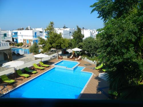 an overhead view of a swimming pool with chairs and umbrellas at Ioanna Apartments in Agios Prokopios