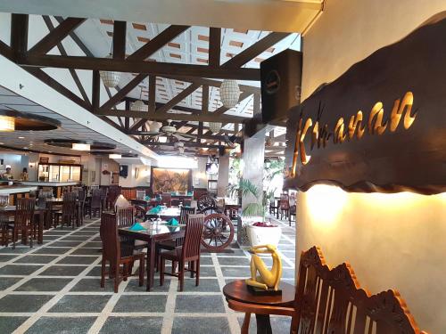 a dining room with a table and chairs at Cebu Parklane International Hotel in Cebu City
