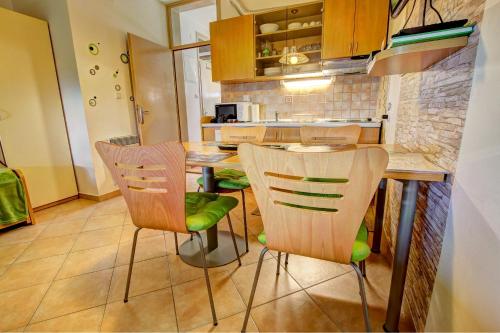 a kitchen with a table and chairs in a room at Apartma David Rogla in Zreče
