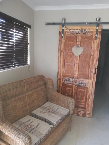 a living room with a couch and a door at Elim Guesthouse in Keimoes