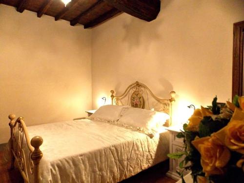 a bedroom with a white bed in a room at Tenuta Poggio Marino in Dicomano
