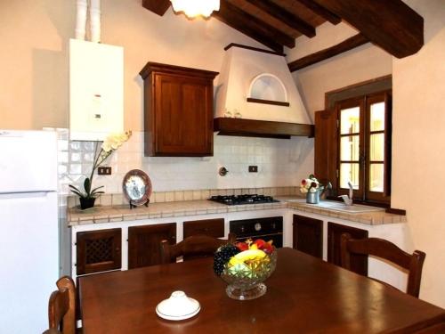 a kitchen with a table with a bowl of fruit on it at Tenuta Poggio Marino in Dicomano