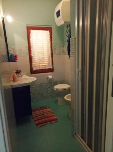 a bathroom with a toilet and a sink at Residence Covo degli Dei in Milazzo