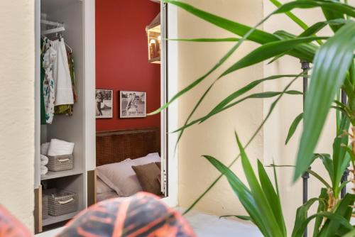 a mirror in a room with a bed in it at Apartamentos Mariscal in Seville