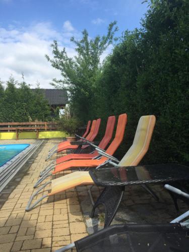 a group of chairs sitting next to a pool at Ubytování U draka in Třeboň