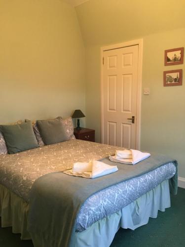 a bedroom with a bed with two towels on it at Airdenair Guest House in Edinburgh