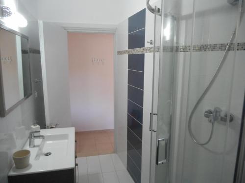 a bathroom with a shower and a sink at Molos Beach Apartments in Paleokastritsa