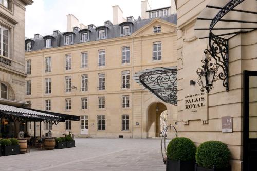 a large building with a sign in front of it at Grand Hôtel Du Palais Royal in Paris