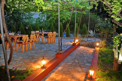 a patio with a table and chairs and lights at Apartments Amigo in Kotor