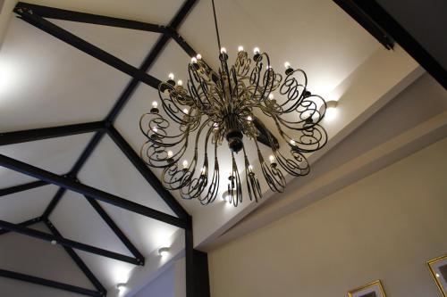 a chandelier hanging from a ceiling in a room at Best Western Plus Pastures Hotel in Doncaster