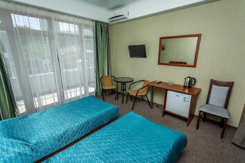 En eller flere senger på et rom på Hotel Edem
