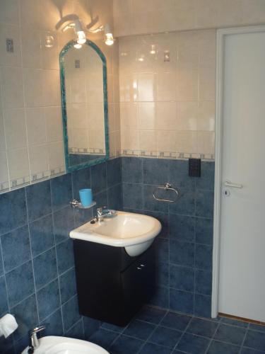 a bathroom with a sink and a toilet and a mirror at Cabaña Lecalau in Lago Puelo