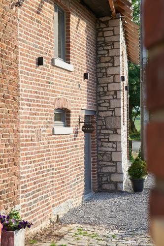 a brick building with a door and a window at B&B Barvaux, Durbuy in Durbuy