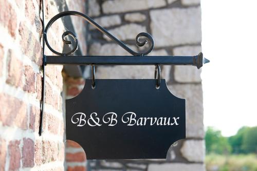 a black sign hanging on a brick wall at B&B Barvaux, Durbuy in Durbuy