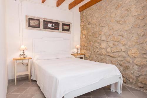 Кровать или кровати в номере Sa Casa De Ses Bicicletes