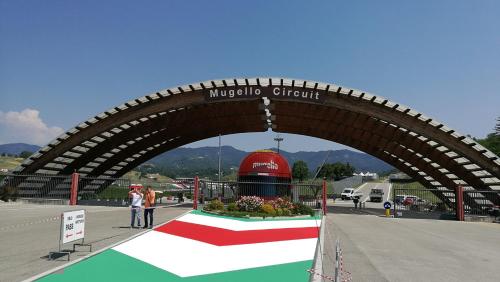 a bridge over a race track with people standing under it at Attico a Barberino di Mugello in Barberino di Mugello