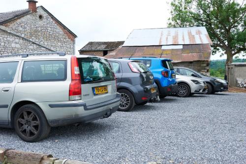 a row of cars parked in a parking lot at B&B Barvaux, Durbuy in Durbuy
