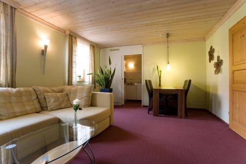 a living room with a couch and a table at Pension Sommer in Waldsassen