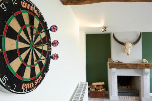 a dartboard hanging on a wall in a room at B&B Barvaux, Durbuy in Durbuy