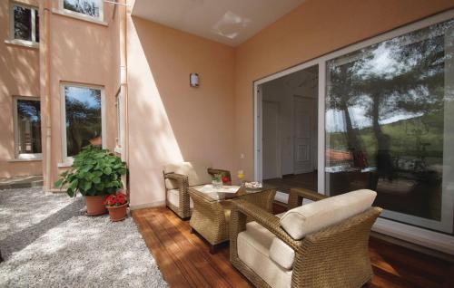 a living room with wicker chairs and a table at Apartment Zanetic in Prizba