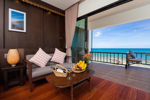 a living room with a couch and a table at Simple Life Cliff View Resort in Koh Tao
