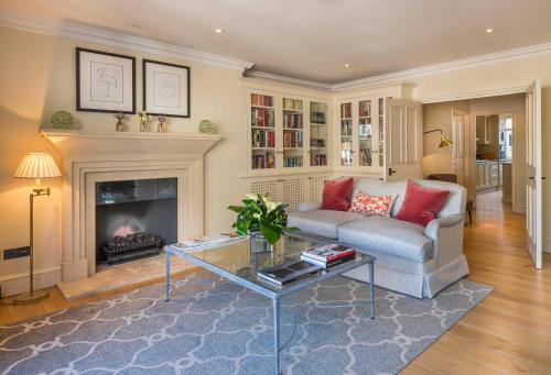 a living room with a couch and a fireplace at The Capital Hotel, Apartments & Townhouse - Small Luxury Hotels of The World in London