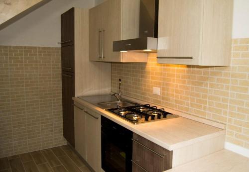a small kitchen with a stove and a sink at Borgo Antico in Portocannone