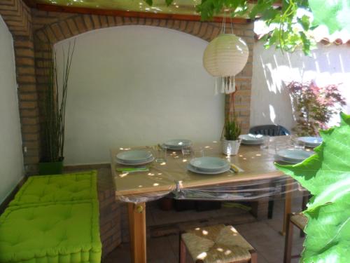 a table with plates on it in a room at Maison Mare & Monti in Pesaro
