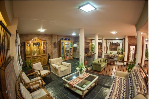 a living room with chairs and a table at Hotel Bahia Nueva in Puerto Madryn