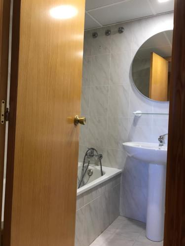 ein Badezimmer mit Waschbecken, Toilette und Spiegel in der Unterkunft Apartamento PortSaplaya in Port Saplaya