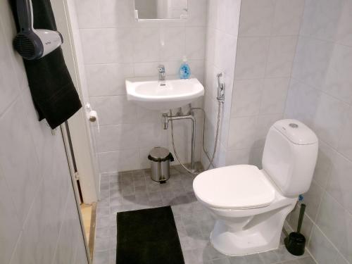 a small bathroom with a toilet and a sink at 2ndhomes Kamppi Apartments 2 in Helsinki