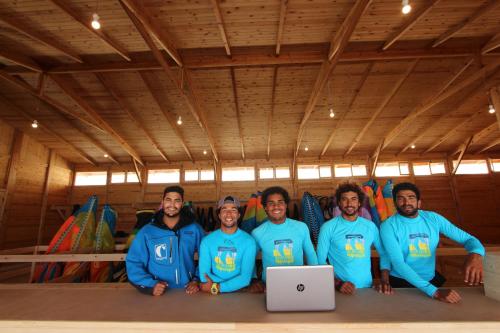 a group of people posing for a picture in front of a laptop at Hotel Dakhla Club in Dakhla