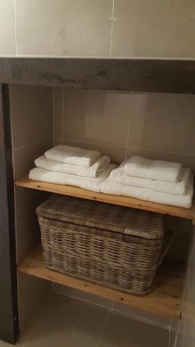 a shelf with towels and a basket on it at Historic Hideaway in Cork City Centre in Cork