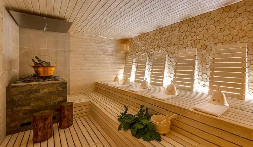 a sauna with a row of windows in a room at Hotel Dębowy Biowellness & SPA Góry Sowie in Bielawa