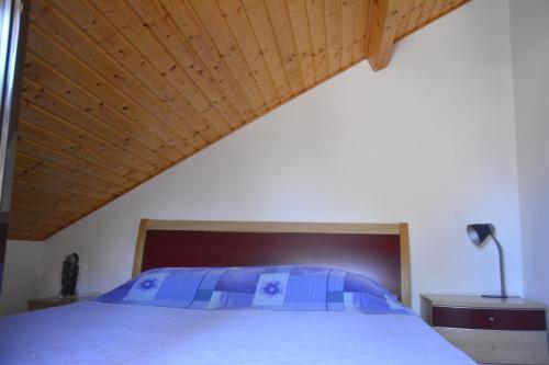 a bedroom with a bed with a wooden ceiling at Apartments Bakuk in Stari Grad