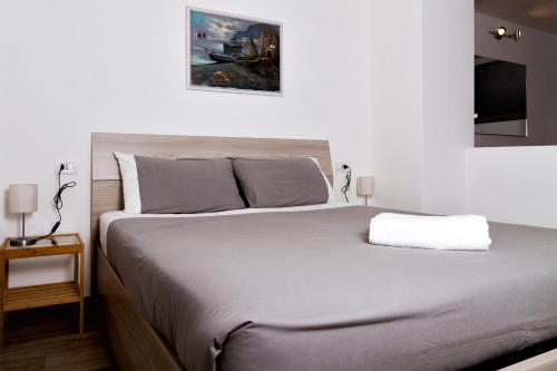 a bedroom with a large bed and a tv at Andirivieni Bellagio Guest House in Bellagio
