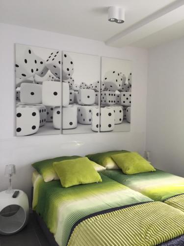 a bedroom with a bed and some playing cards on the wall at Apartament in Kołobrzeg